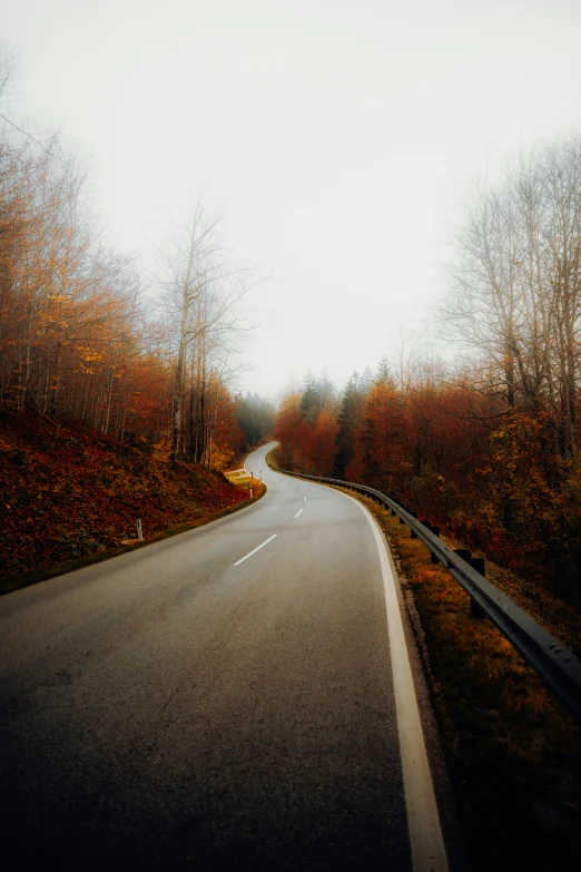 a winding highway in the country is shown in a blurry po