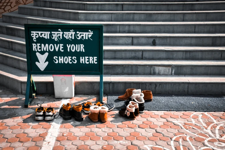 a group of teddy bears on the ground next to a sign