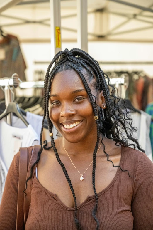 there is a woman with long dreadlocks and brown shirt