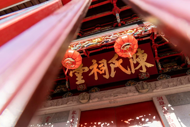 an oriental shrine in the sun with lanterns
