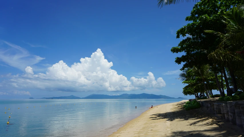 a sandy beach on the island side of the ocean