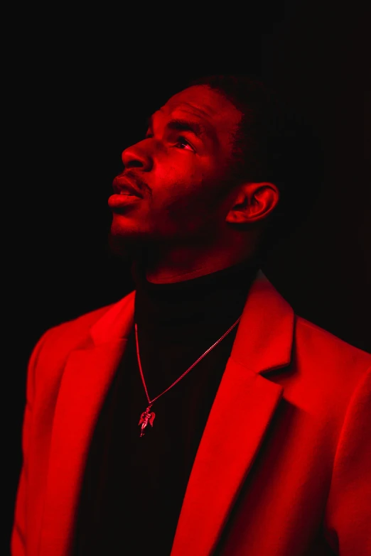 a black man wearing a red suit