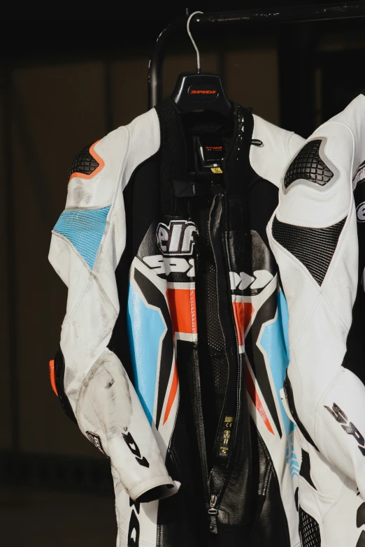 a white and blue motorcycle jacket with orange details