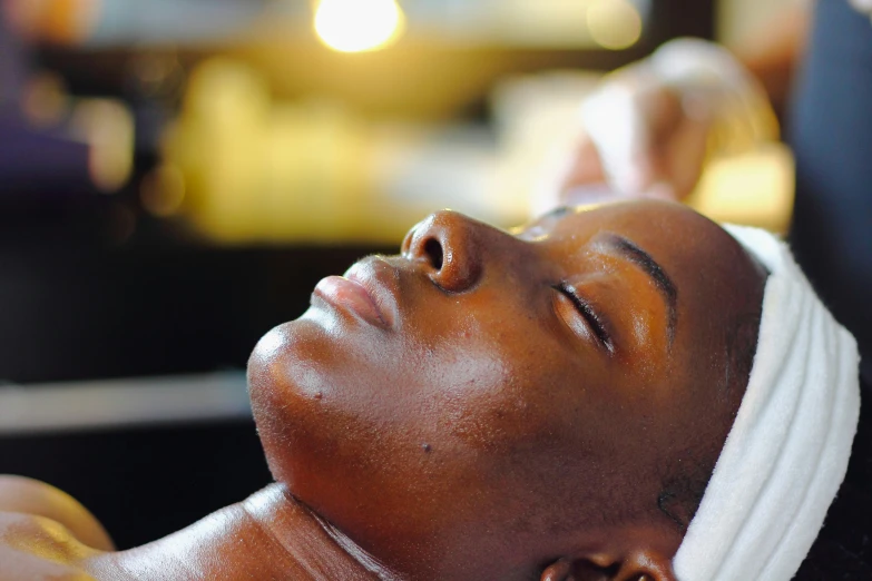 a woman getting a facial scrub by herself