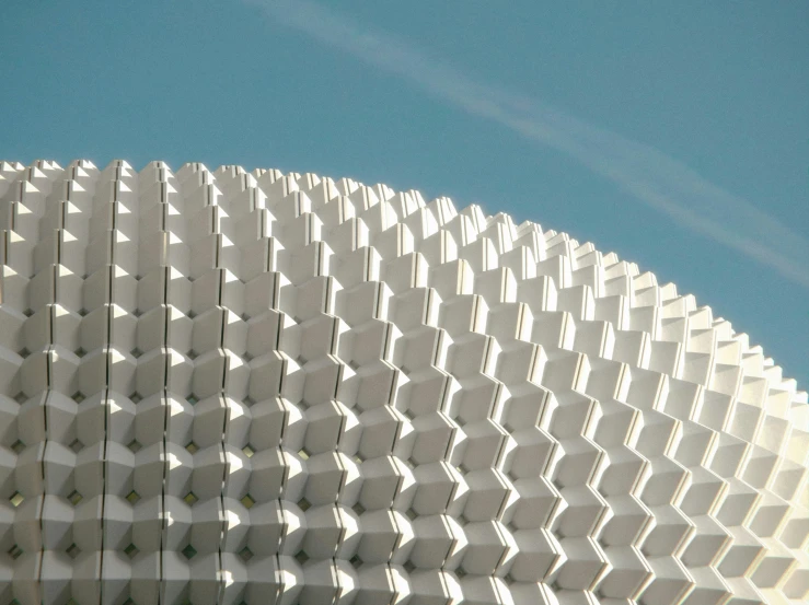 a building designed to look like an abstract diamond with some very big white patterns on it