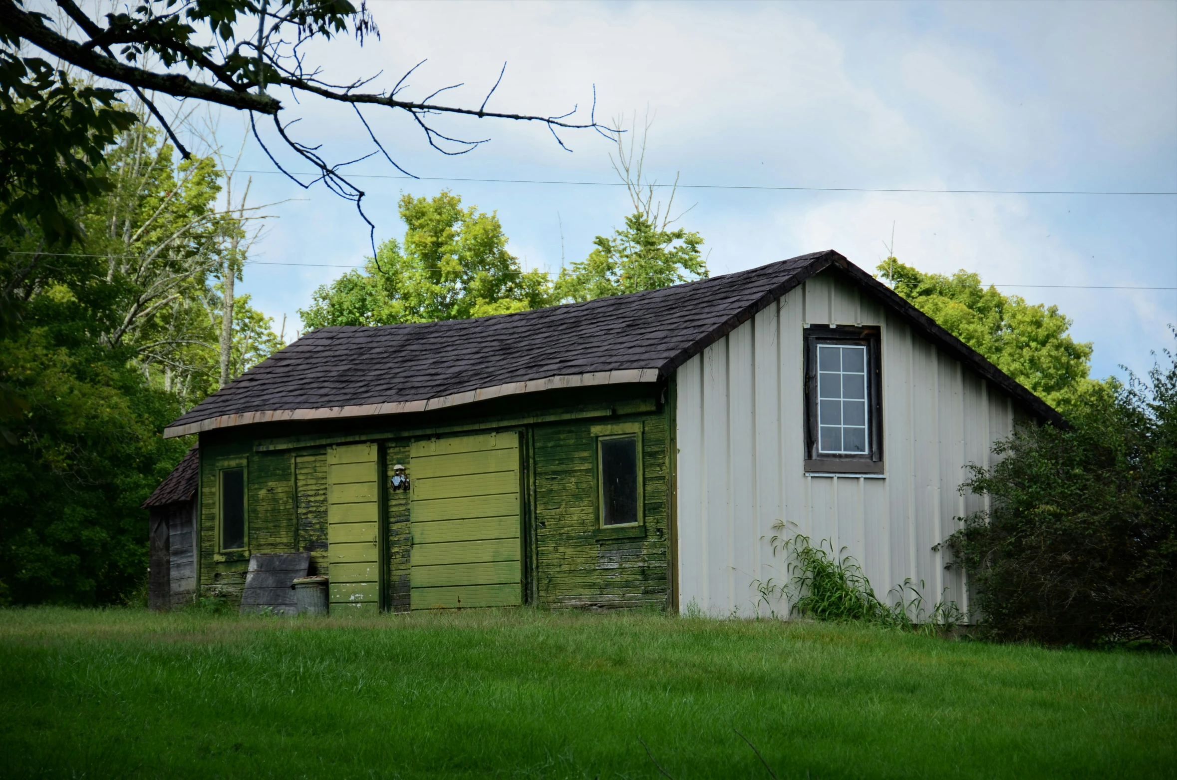 an old house with a little porch in the yard