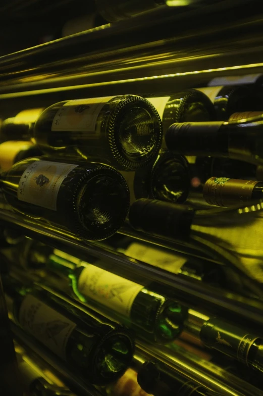 a close up of several bottles of wine sitting on top of a metal shelf