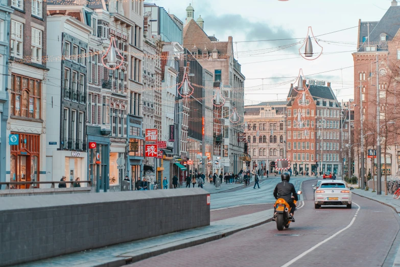 a man on a motorcycle travels down a crowded street