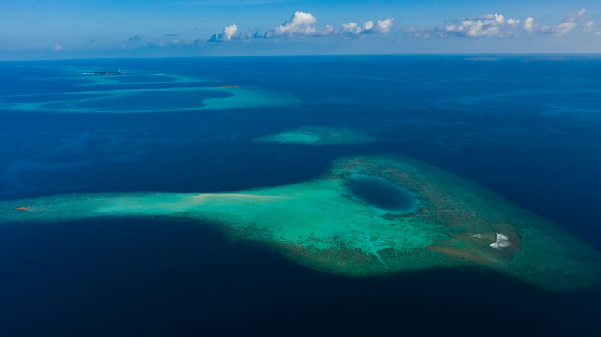 an aerial view of some pretty blue water