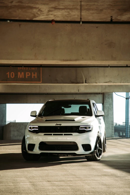 white dodge ram is parked under an overpass