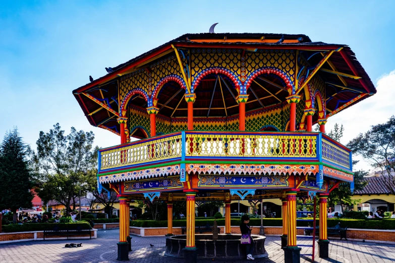 a very colorfully decorated gazebo in the park