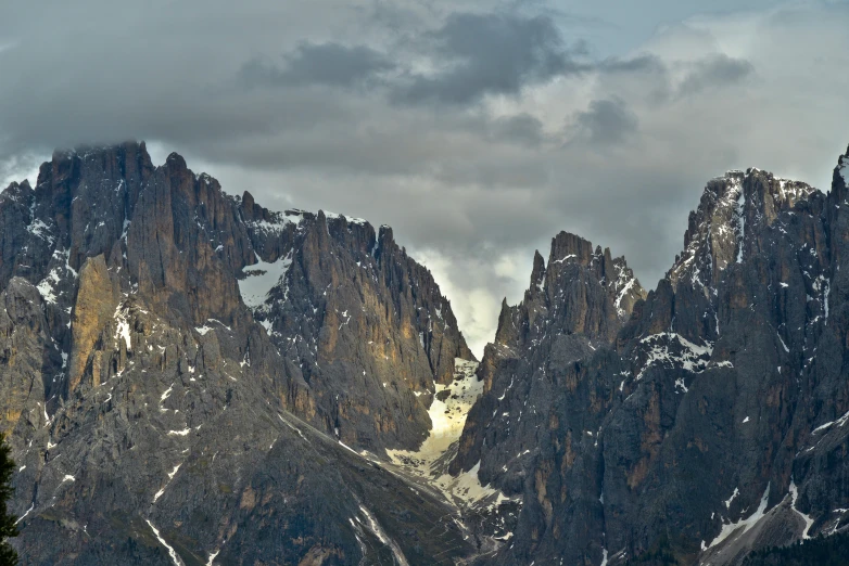 snow - covered mountains against cloudy skies and gray skies