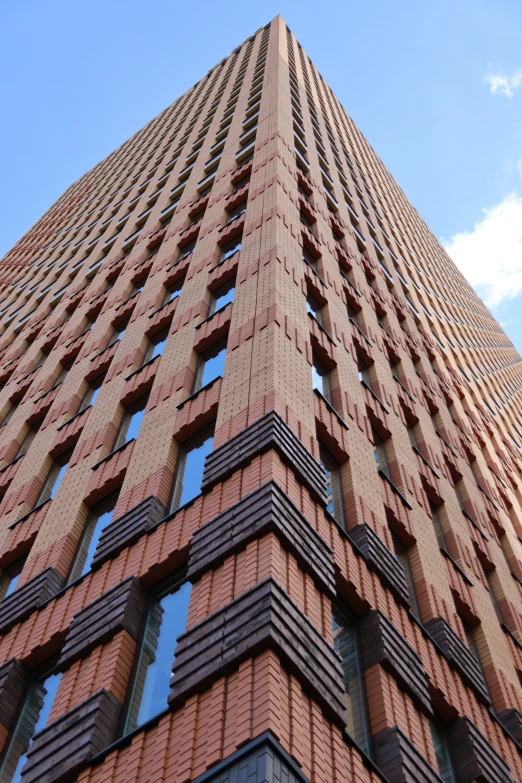 the bottom of an architectural skyscr, looking up at the sky