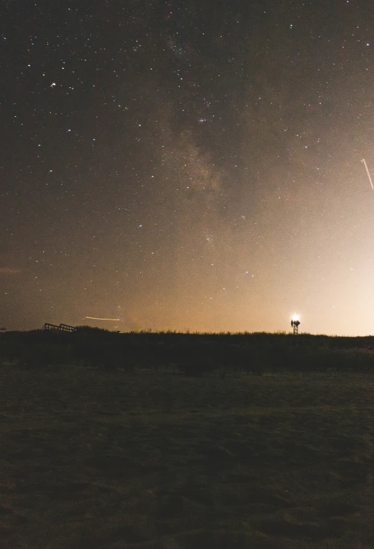 a view of the sky at night with stars above it