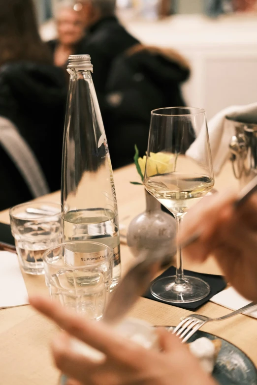 people having wine with white wine at a table