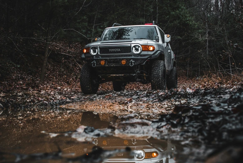 a large truck is parked on the muddy ground