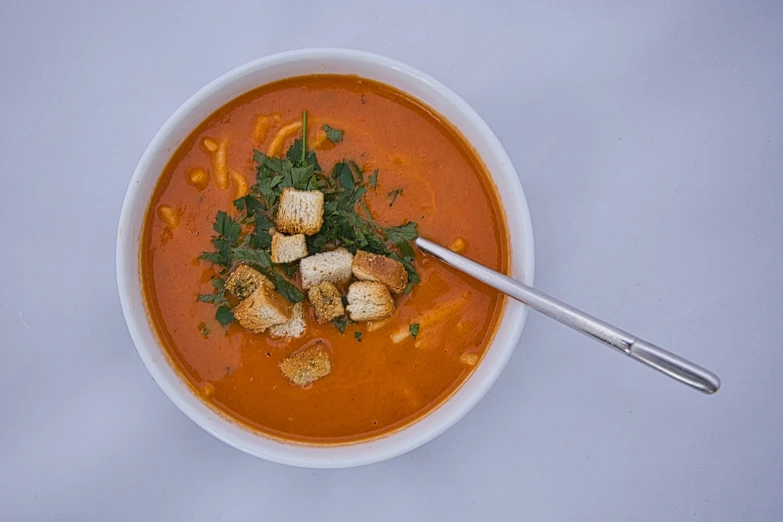 a bowl of food on top of a white table