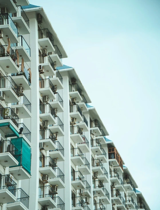 an apartment building with several balconies and a clock