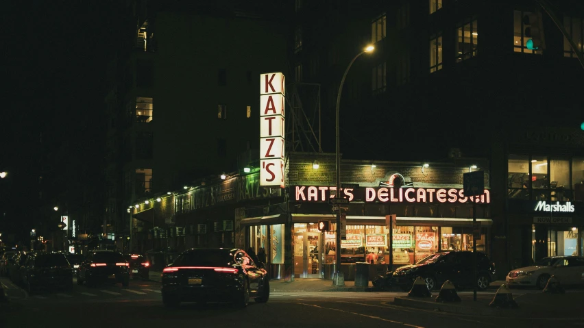 an illuminated business called kalliss deli and steak on the corner of a street