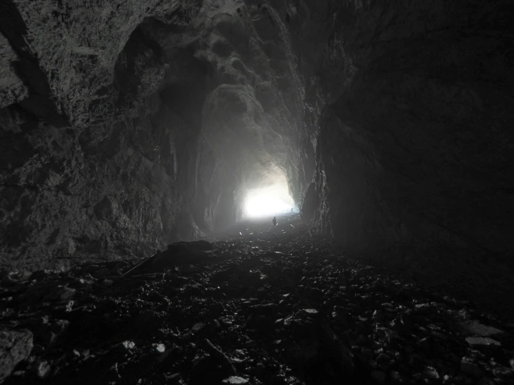 a light at the end of a dark cave entrance