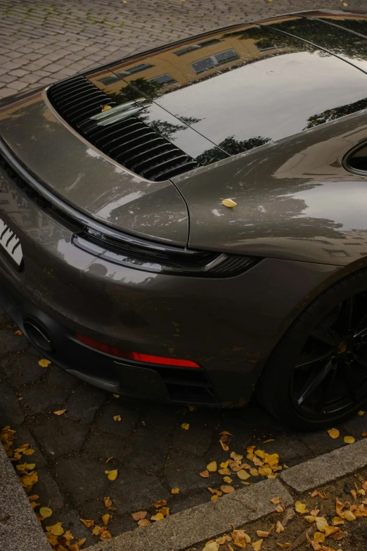 a gray sports car parked on the side of the road