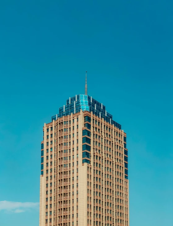 a tall brown building with blue balconies near a street