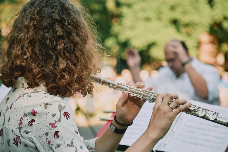 a young woman is holding the strings of her flute