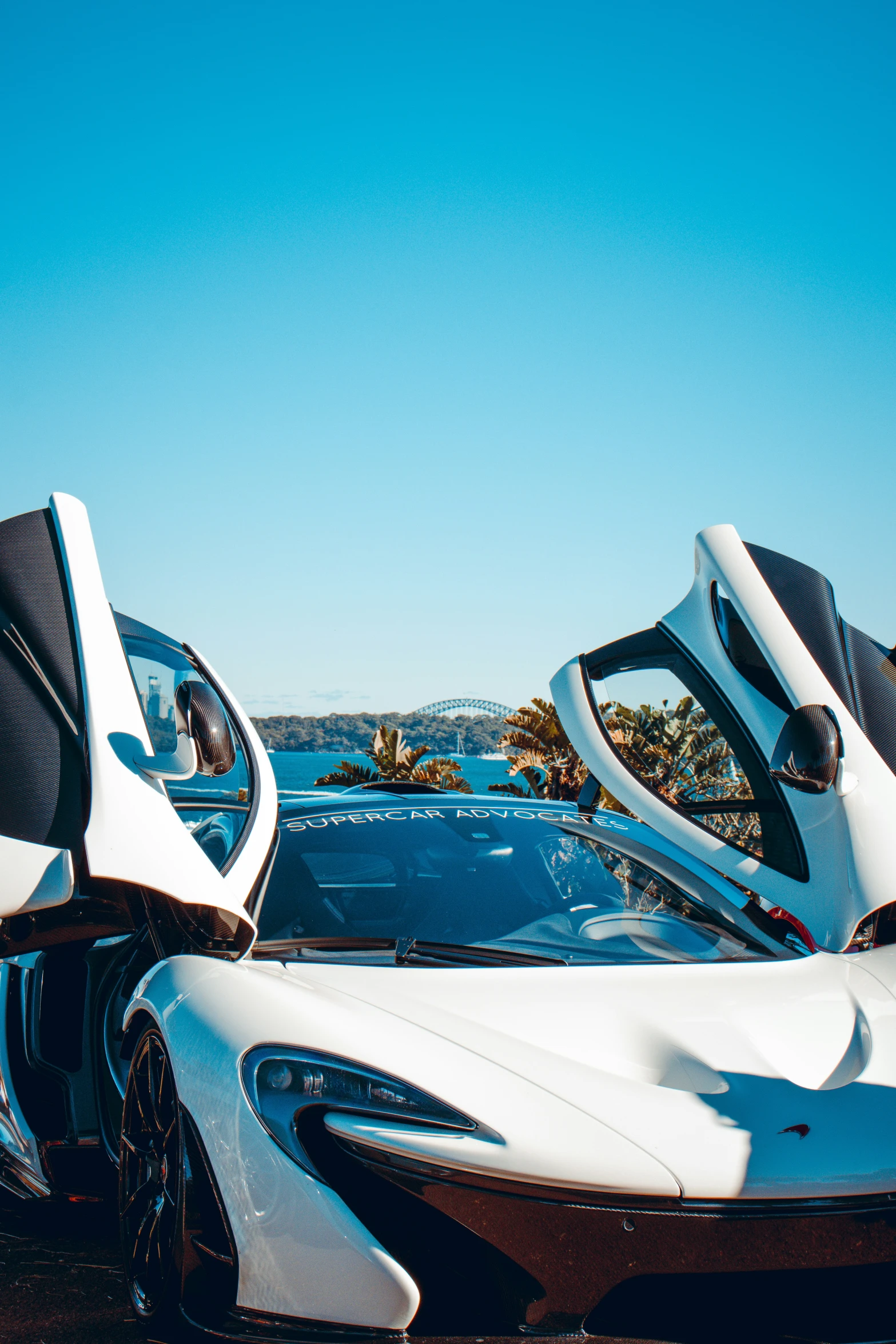 a parked sports car sitting on top of a beach