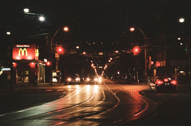 an intersection with the light turned on in the evening