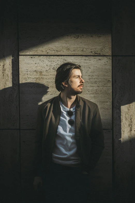 a man stands with his back to the camera in a dark room