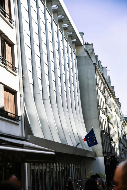 a city street lined with tall white buildings