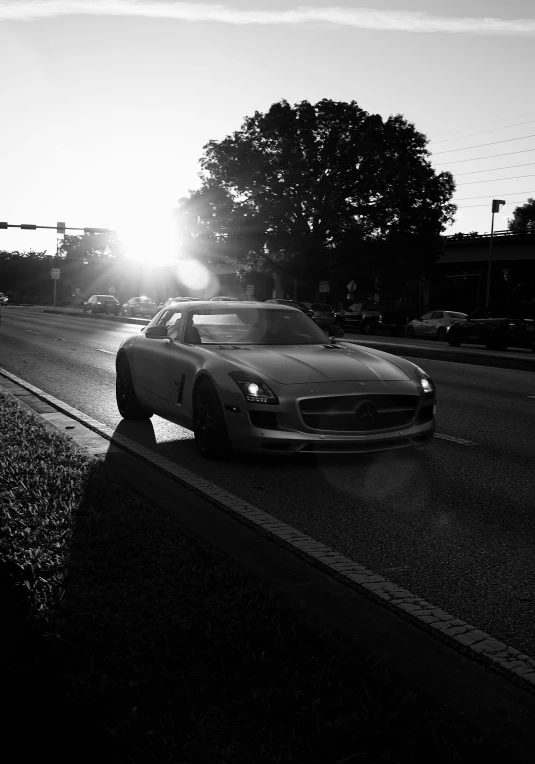 a car on the road in front of the sun