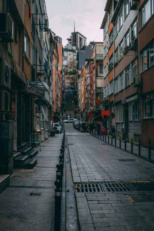 a narrow city street has buildings all around it