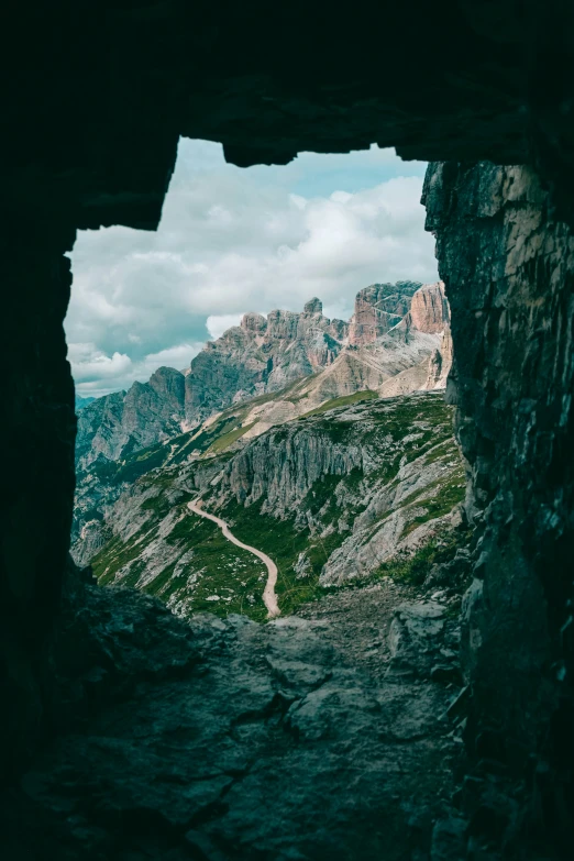 the view of some mountains from inside a cave