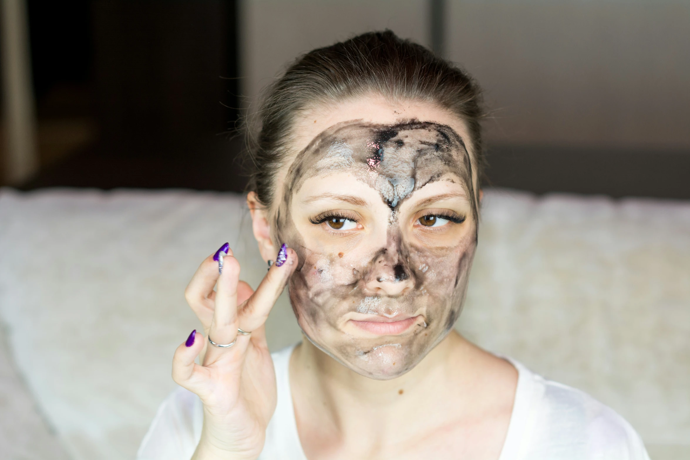 a woman has a picture with black and white paint all over her face