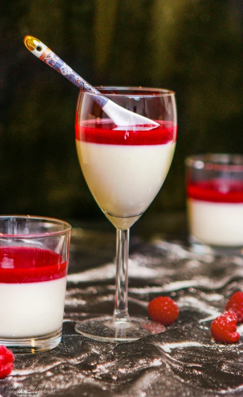 two glasses of red liquid sit on the table