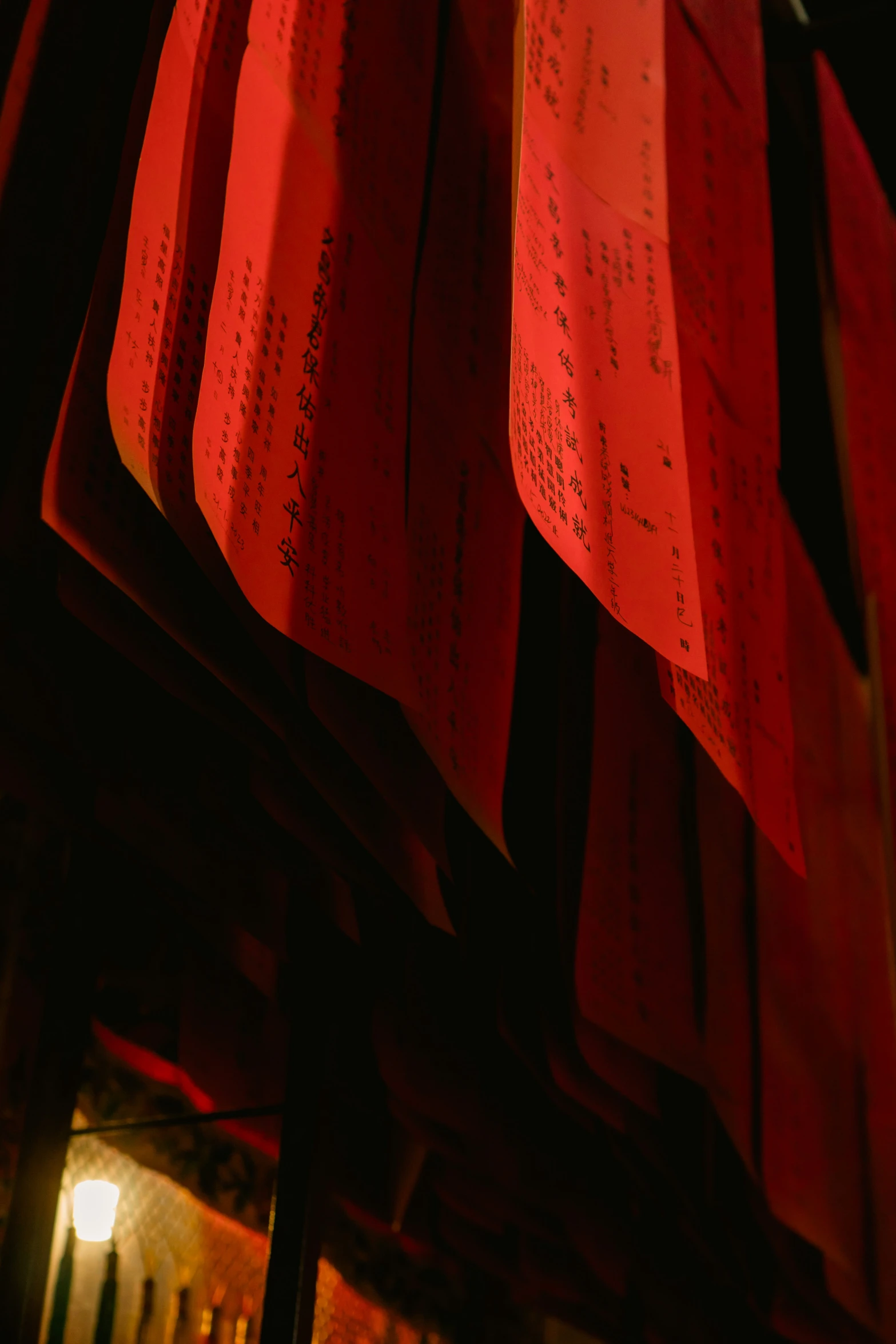 a red and yellow display has paper writing on it