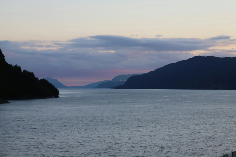 a couple of mountains near a body of water