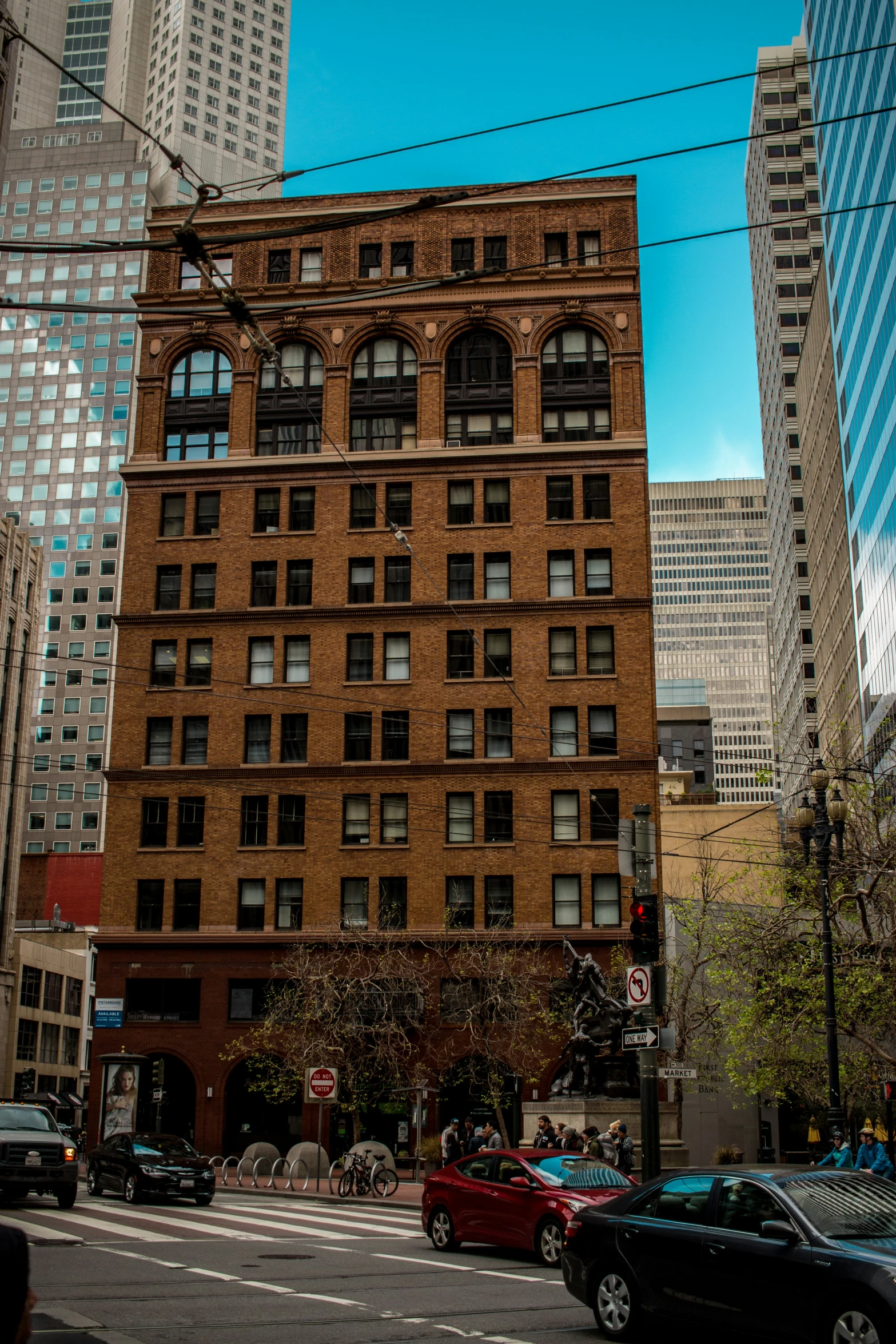 a tall building sits near an intersection on a city street