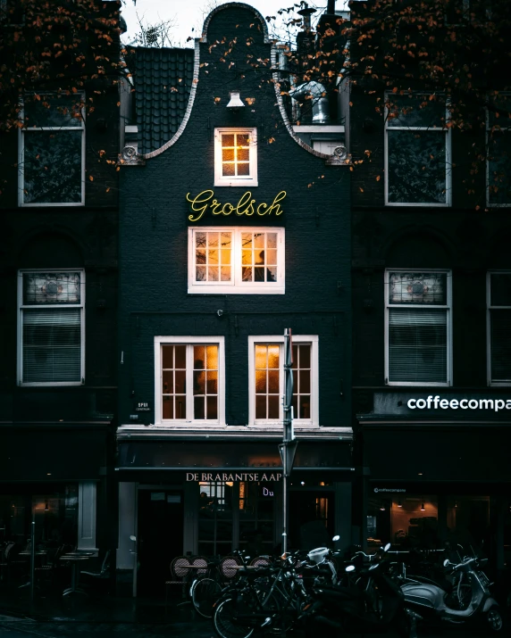 two bicycles parked in front of a dark building