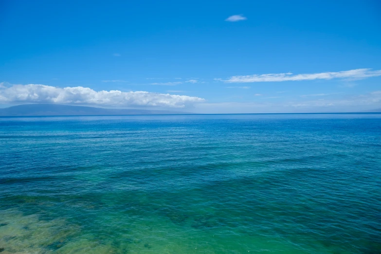 the ocean is clear and blue under the blue sky