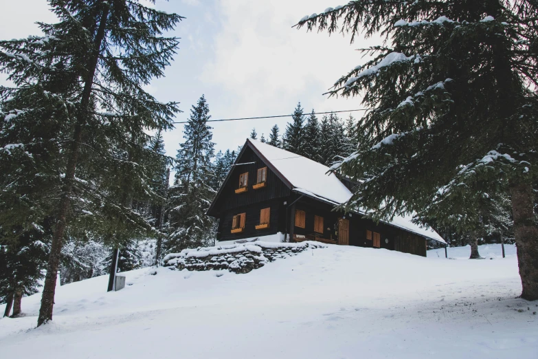 a house is on top of a snowy mountain