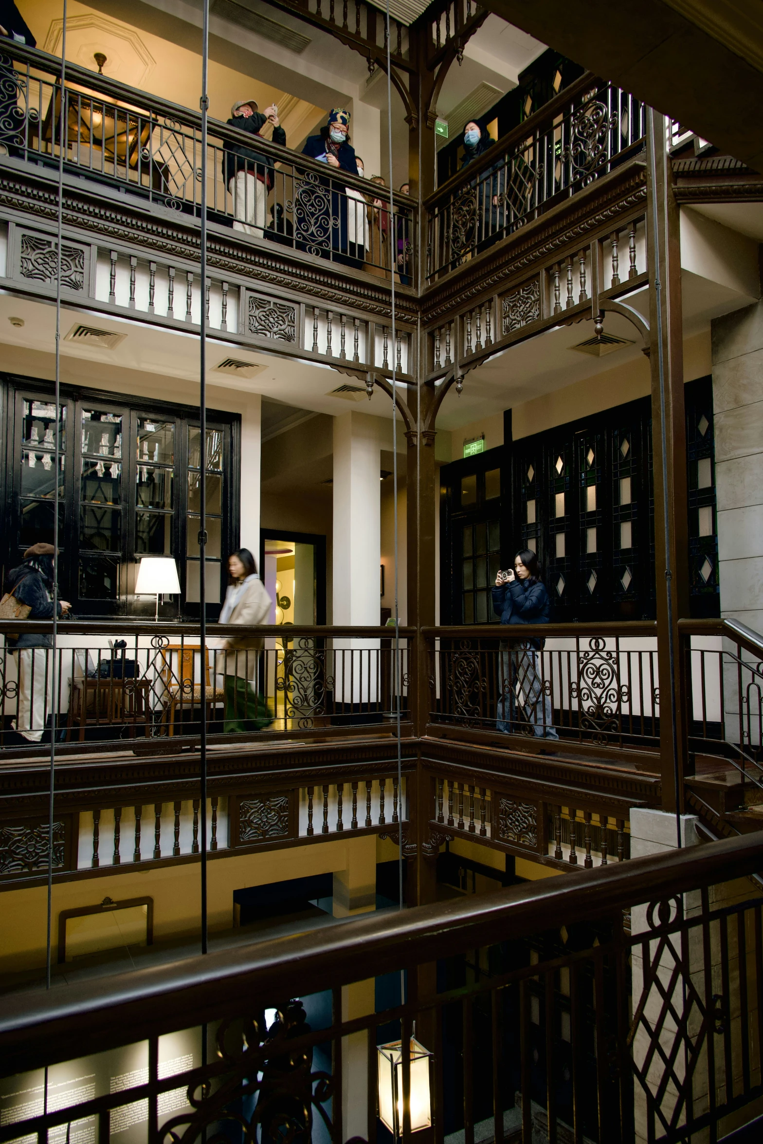 the inside of a building with several people standing around