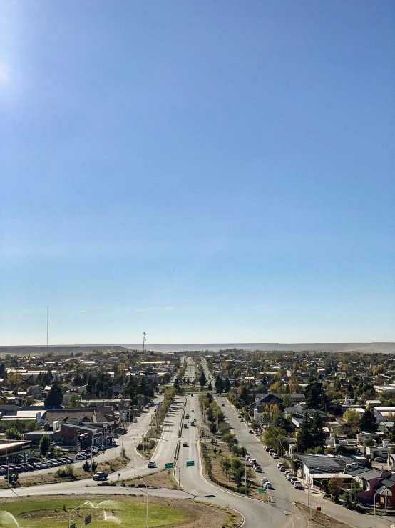 a city with several cars, a street and a parking lot