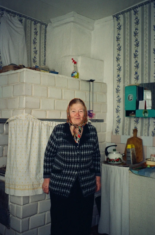 the older woman is standing in front of the shelves in the room