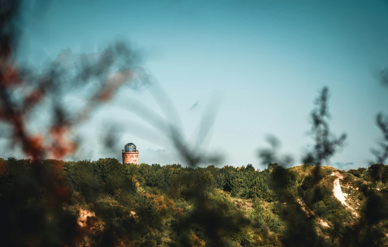 a tower in the distance sits atop a hill