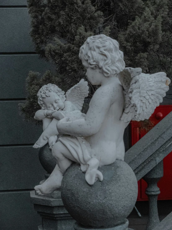 an angel statue sitting on top of a pedestal