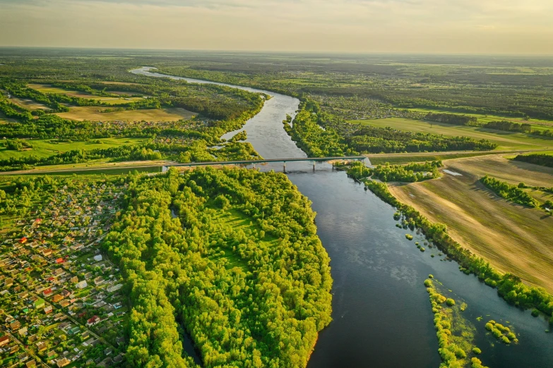 an aerial po of a river and a bridge