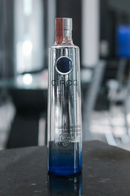 a bottle filled with blue liquid sitting on a table