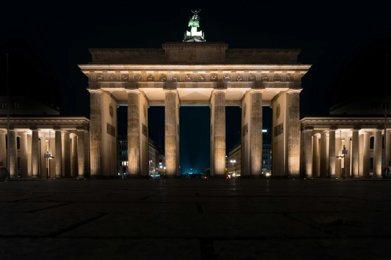 three very tall pillars lit up at night